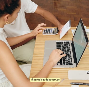 a woman sitting at a desk with a calculator