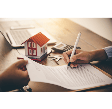 a person holding a pen and writing on a paper