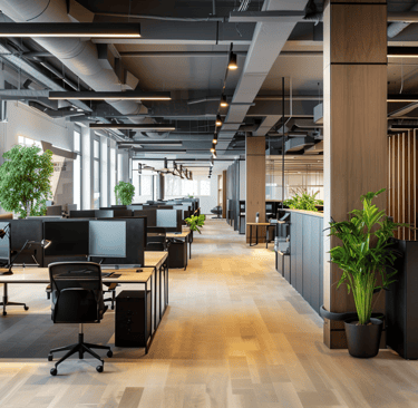 An office environment featuring multiple computers on desks, with a modern interior design that incl