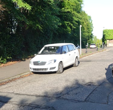 Cars parked at the bottom of Murrayfield Gardens