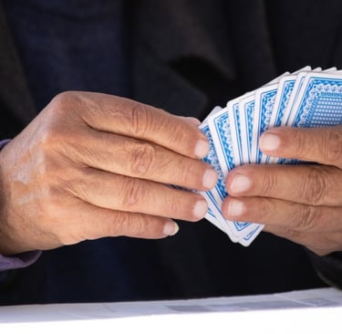 Person holding playing cards