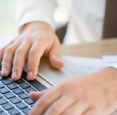 Home de paletó e gravata digitando em teclado