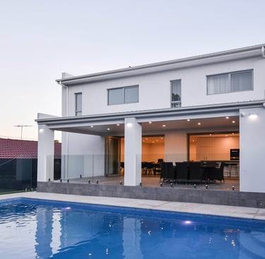 a house with a pool and a pool in the background