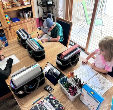 3 kids homeschooling at the table