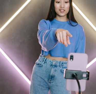 a girl creating video content for social media. an impact of mass media on socialization.