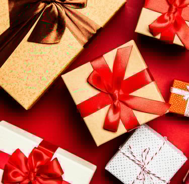 a bunch of gift boxes with bows on a red background