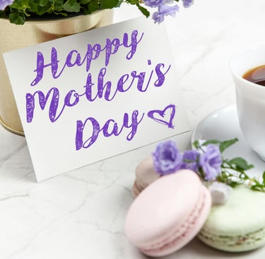 a cup of coffee and a card saying happy mothers day