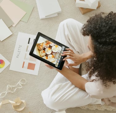 a woman sitting on a rug with a tablet