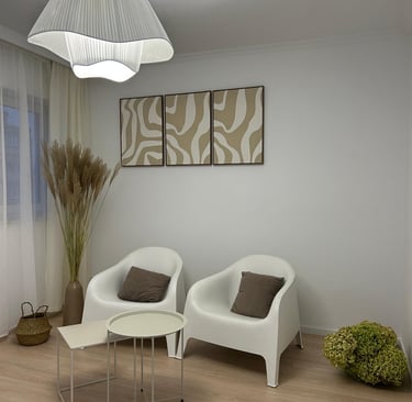 a living room with a white chair and two chairs