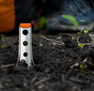boglerco trowel stuck in ground with backpack and boots in background
