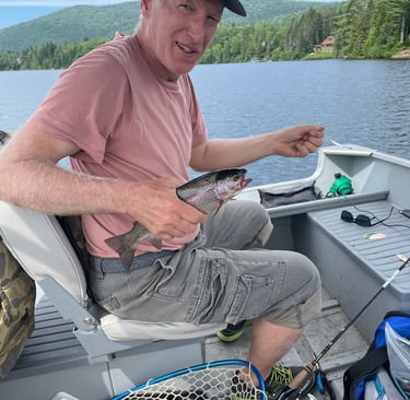 Client catching rainbow trout in lakes near Ottawa