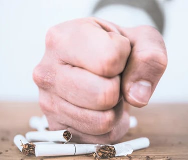 a person holding a cigarette in their hand