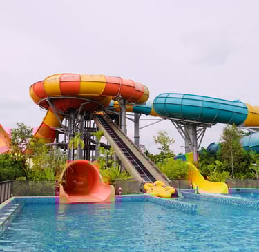 Red and yellow waterslide with a small pool below