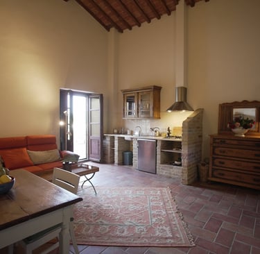 a living room with a couch and a kitchen
