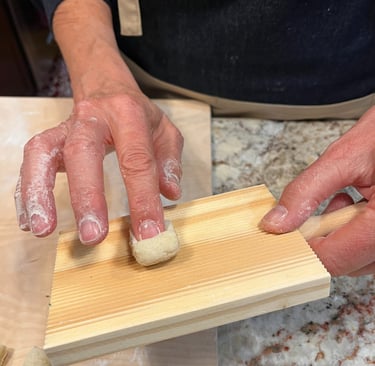 Forming gnocchi on wooden board