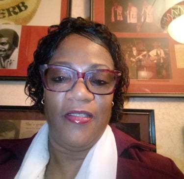 a woman in glasses and a scarf around her neck