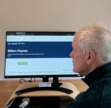 Photo of a man viewing the Local Government Boundary Commission website for Milton Keynes