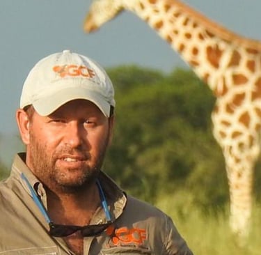 Dr Fennessy portrait with giraffe in background