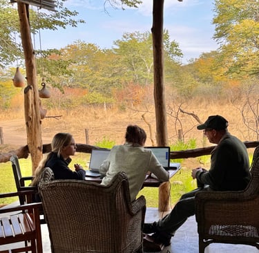 Researchers discussing work on their computers