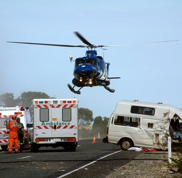 Ambulance and helicopter on scene where paramedics are using POCUS ultrasound.