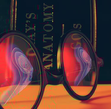 Eyeglasses  lying in front of Gray's Anatomy textbook.