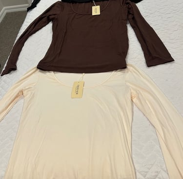 Set of three Ekouaer long sleeve shirts in black, beige, and brown laid out flat.
