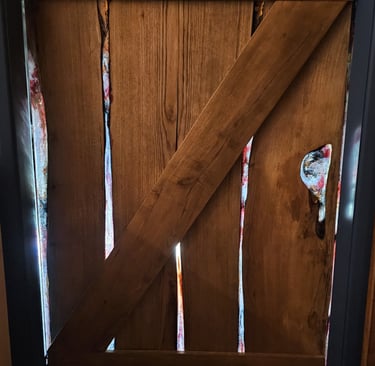 Bottom half of stable door made from resin and hard wood with sunlight shining through the resin.