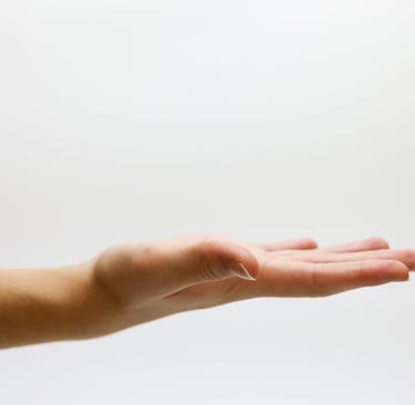 a person's hand is extended and opened  with palm facing up