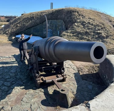 a man standing next to a large cannon