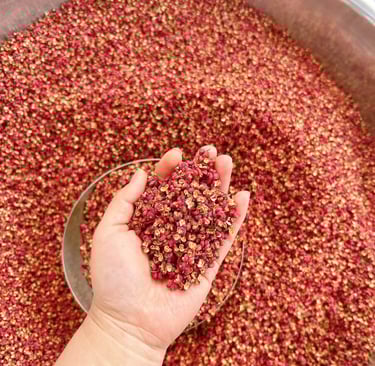 a person holding a spoon of Sichuan Pepper