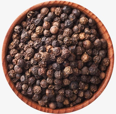 Top down view of organic whole black peppercorns in a small wooden bowl isolated on white.