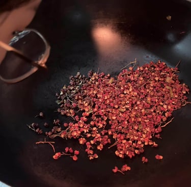 cooking in a wok pan with Sichuan Pepper