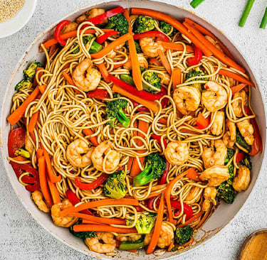 a bowl of noodles with shrimp and vegetables lo mein