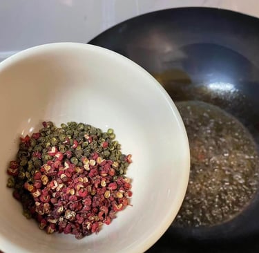 a person holding a bowl of Sichuan Peppers in a bowl