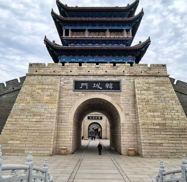 a person walking through a stone wall with a gate