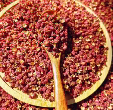 a wooden spoon with Sichuan Pepper