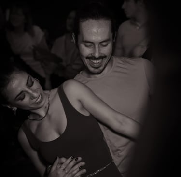 a man and woman dancing at a party