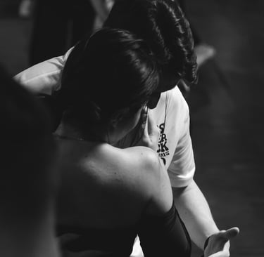 a woman in a white shirt is holding a cell phone