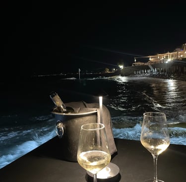 two wine glasses with wine glasses on a table