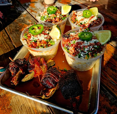 Elote with brisket, cotija cheese, lime and jalapeno with a smoked burnt end with jalapeno