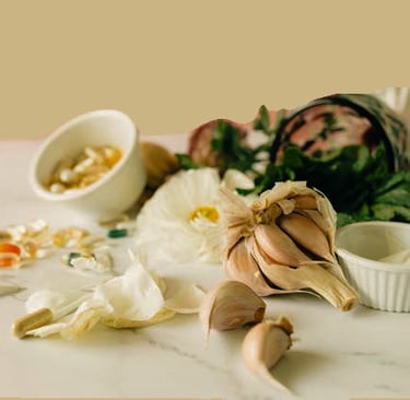 Fresh garlic cloves and herbal supplement capsules on a marble surface for natural wellness.