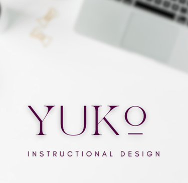 A blurry top down aesthetic desk setup with Yuko Instructional Design written.