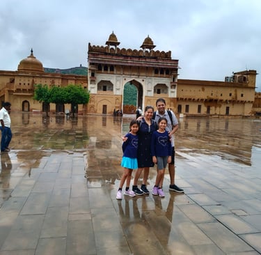a family posing for a picture in front of a building