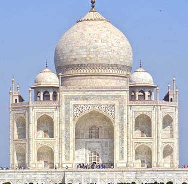 Taj Mahal a large white building with a large dome shaped building