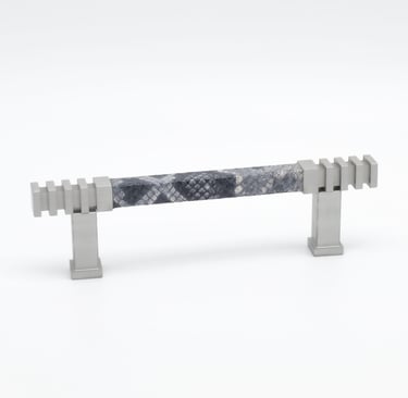 Photography case study featuring a cabinet pull with a leather wrap and silver metal finish.