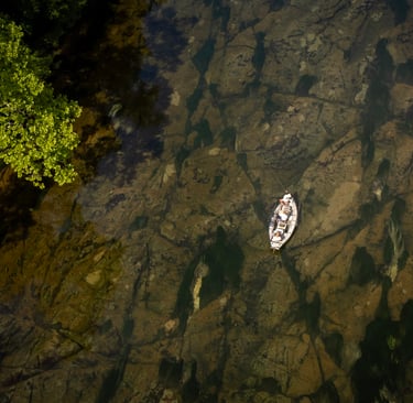 Aerial shot of a drift boat on the South Holston River.