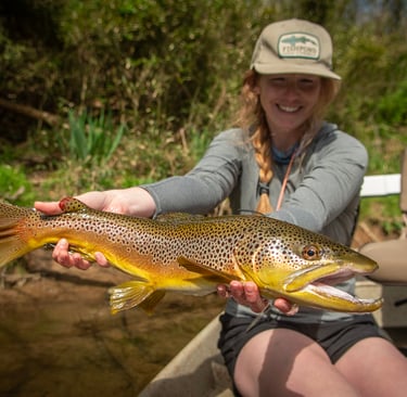 Female Angler shows off trophy brown trout on the Watauga River.