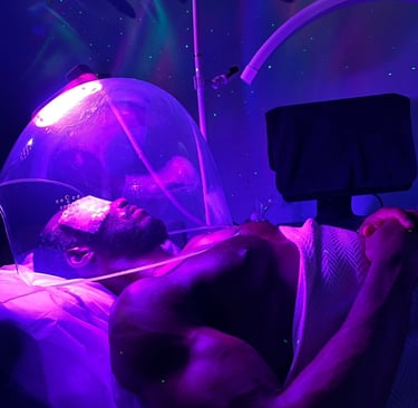 a man at the spa enjoying purple light oxygen dome treatment