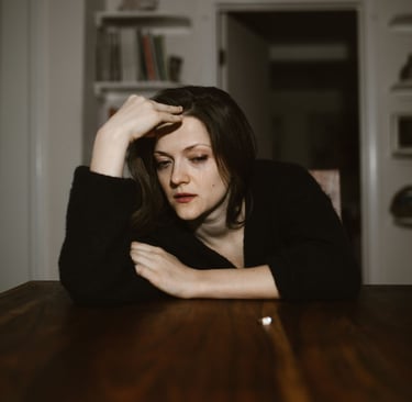 Woman experiencing emotional distress and heavy atmosphere inside her home