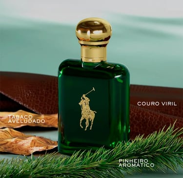 Polo Ralph Lauren green cologne bottle with gold cap near leather, tobacco leaves, and pine.
